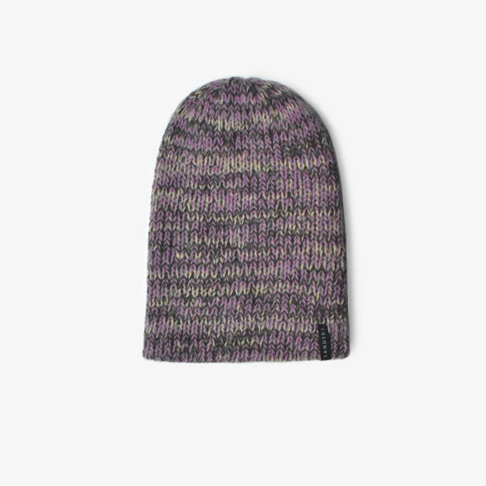 A knitted beanie in purple hues on a white background 