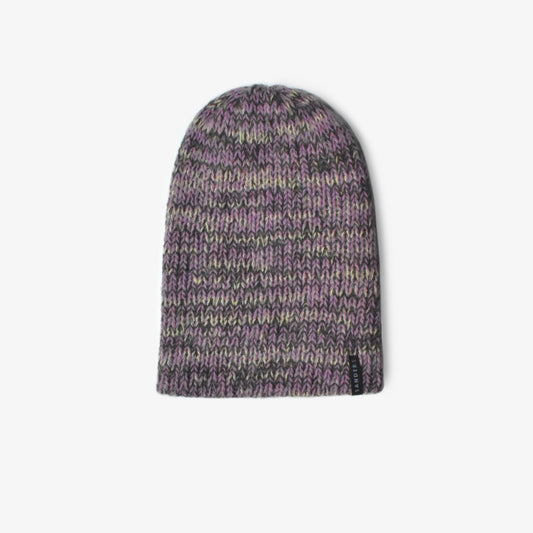 A knitted beanie in purple hues on a white background
