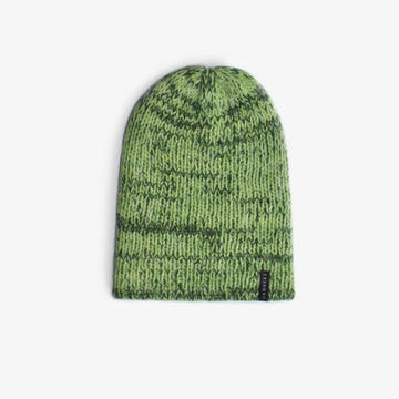 A wooly hat in hues of green on a white background 