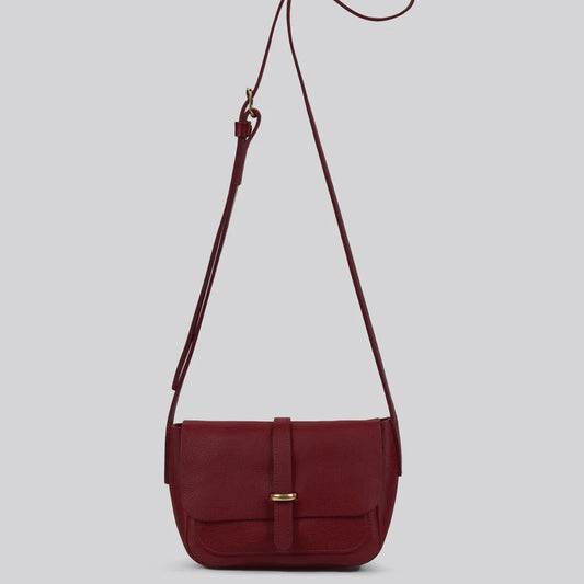Maroon leather shoulder bag with a strap on a light gray background