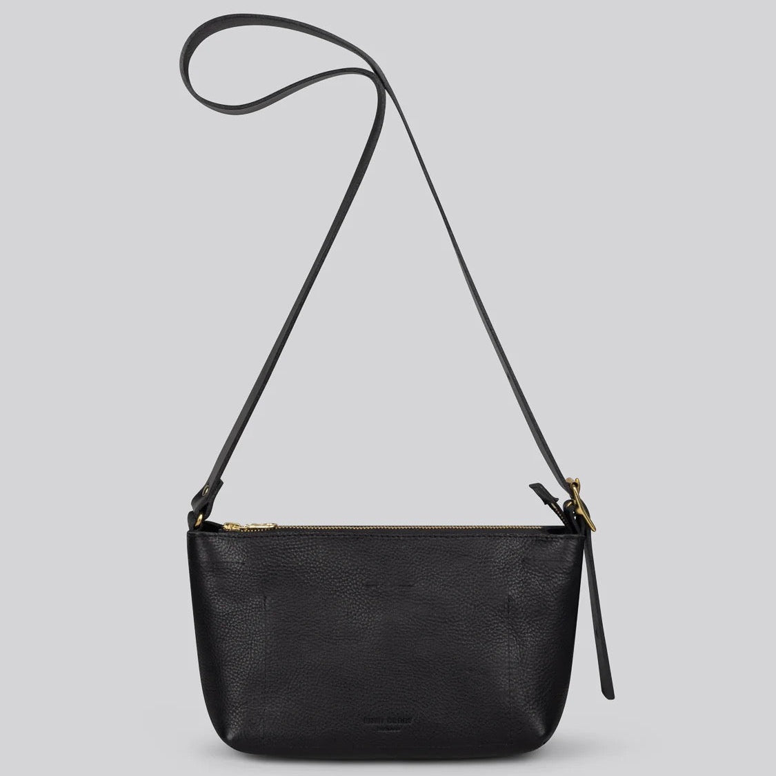 A black pebbled leather crossbody bag with a long shoulder strap and gold-tone hardware, shown against a solid light gray background.