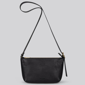 A black pebbled leather crossbody bag with a long shoulder strap and gold-tone hardware, shown against a solid light gray background.