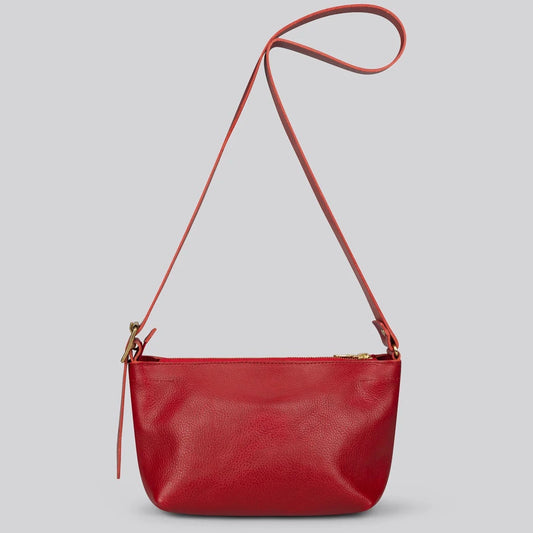 A red pebbled leather crossbody bag with a thin matching shoulder strap and gold-tone hardware, shown against a solid gray background.