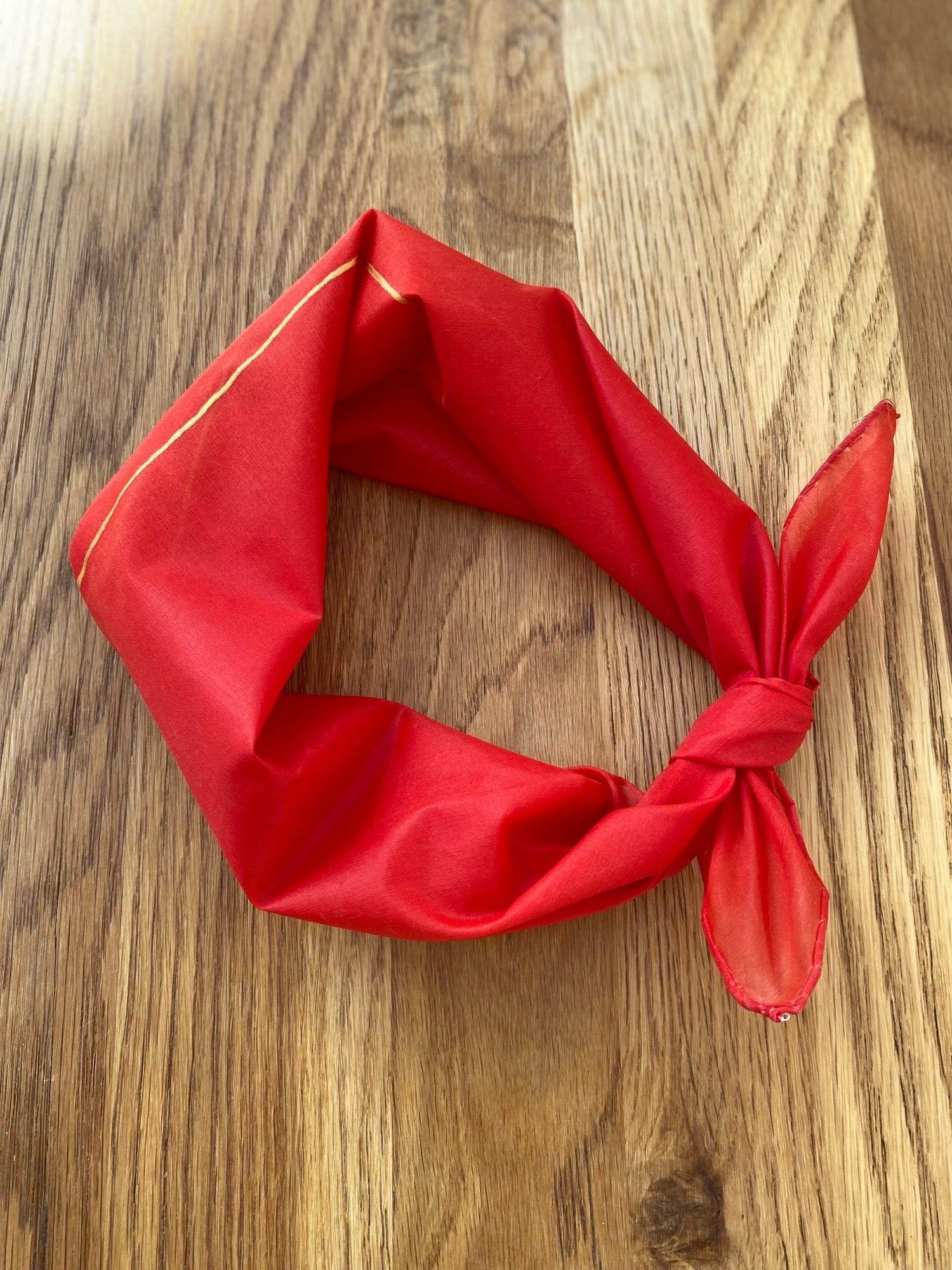 Red neck scarf on a wooden surface