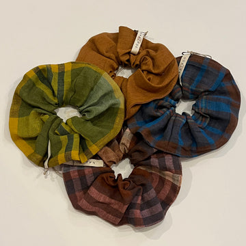 Set of plaid scrunchies in various colors on a white background