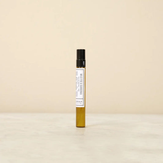 Small perfume bottle with a label on a beige background