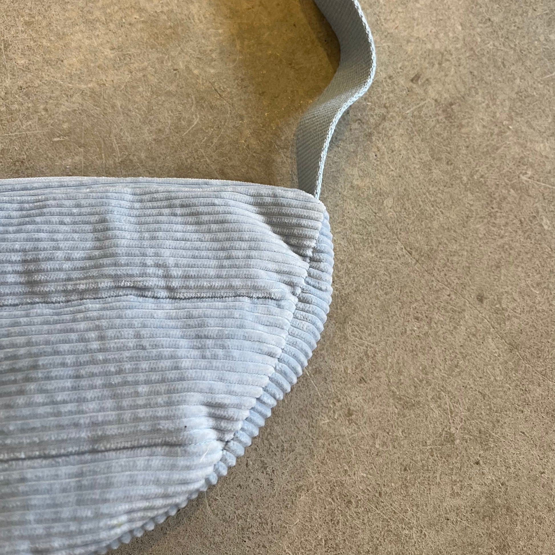 Close-up of a blue textured fabric on a beige surface