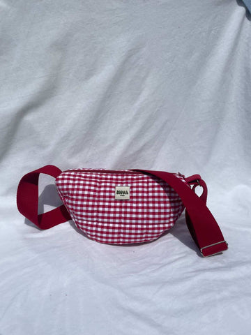 Red and white checkered waist bag with red strap on a white background