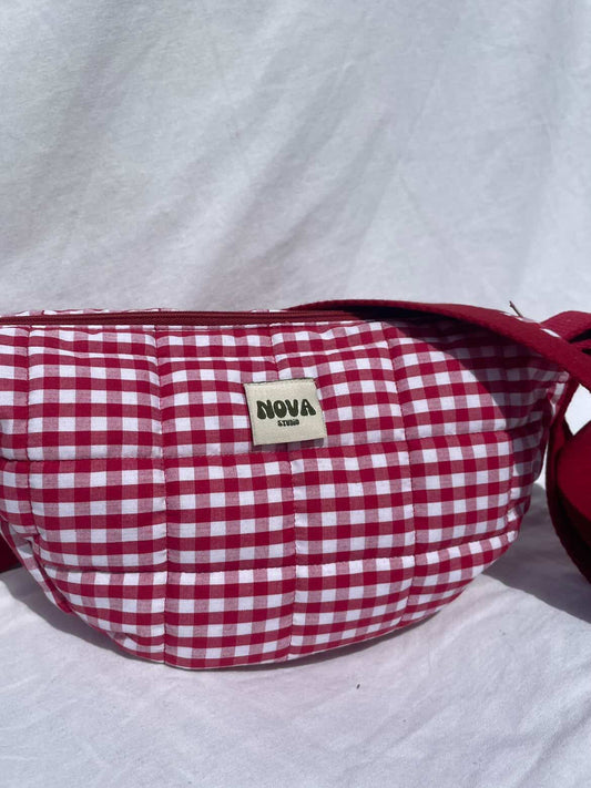 Red and white checkered bag with 'Nova' label on a light gray background
