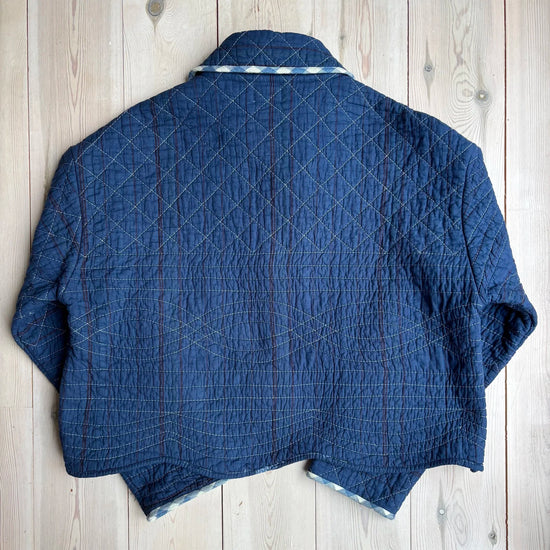 back detailing of a blue jacket on a wooden background 