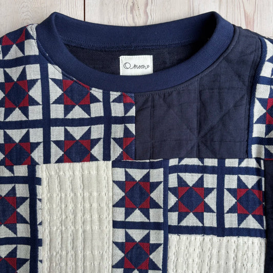 a close up of the neckline on the patchwork sweater