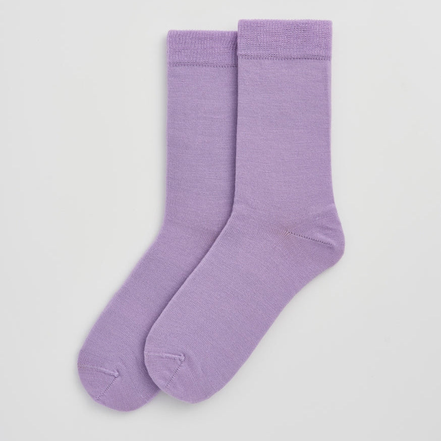 Pair of purple socks on a light gray background