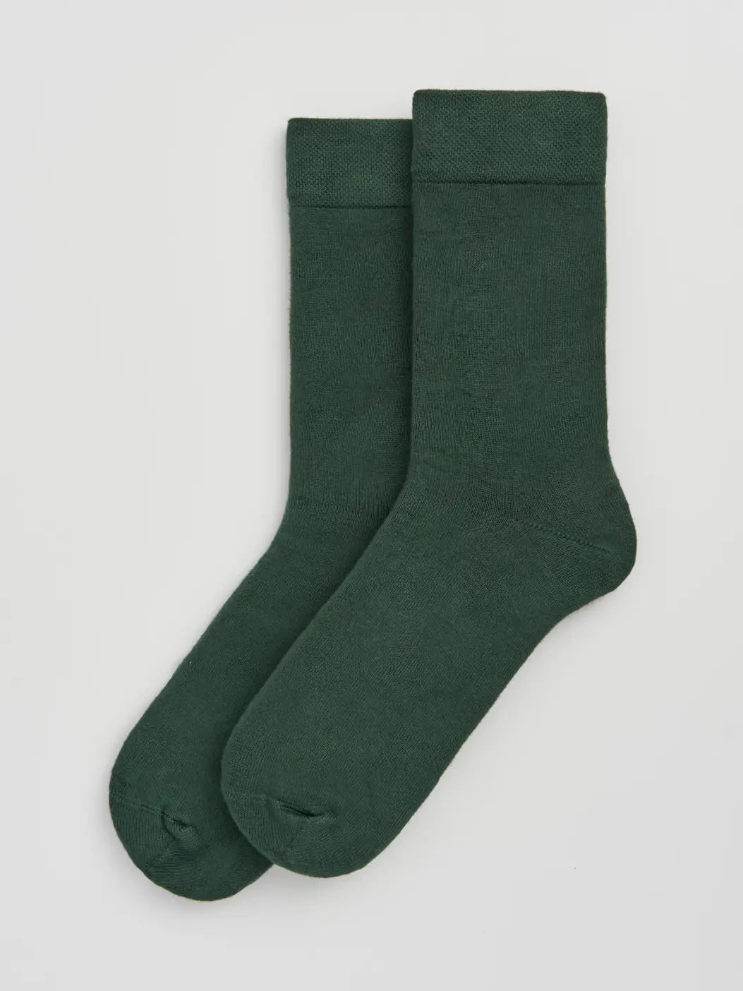 Two green socks on a light grey background
