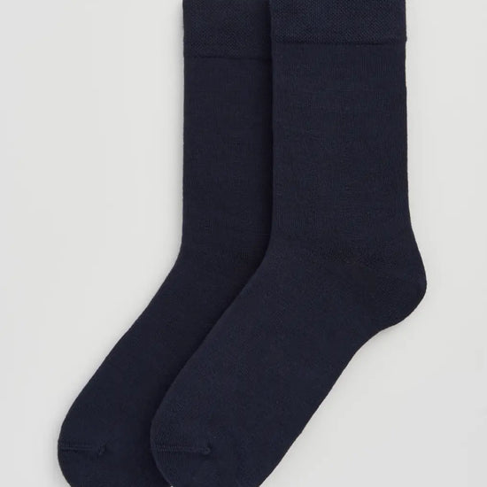 Pair of dark navy socks on a white background