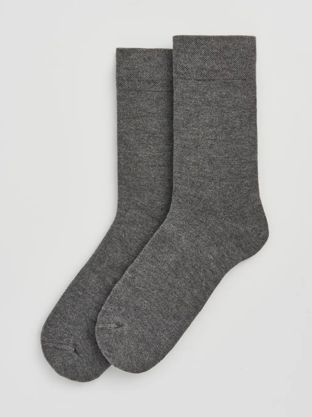 Two gray socks on a light grey background
