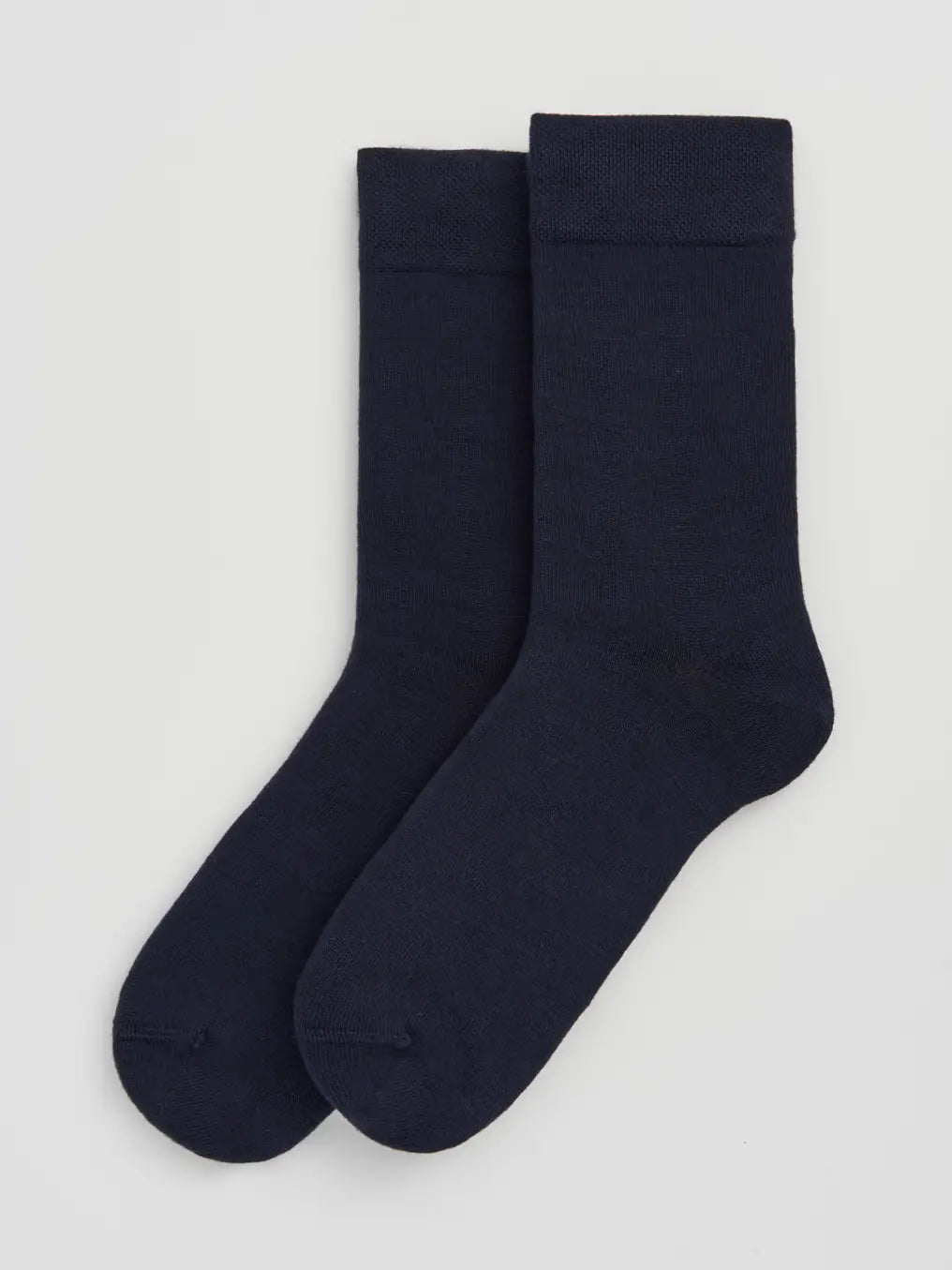 Pair of inky black socks on a white background