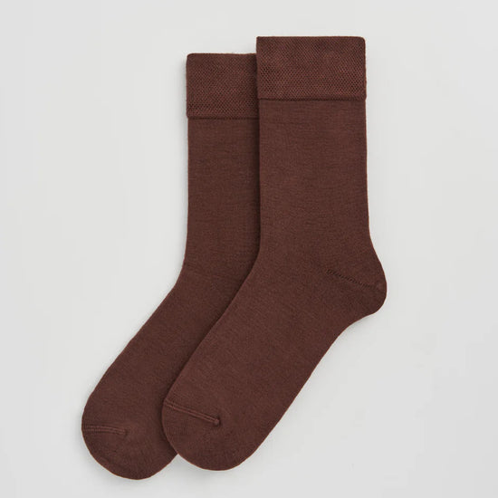 Pair of brown socks on a light grey background