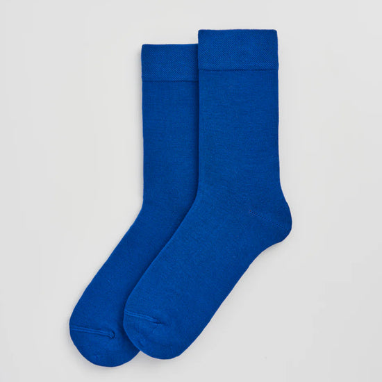 Pair of blue socks on a light grey background