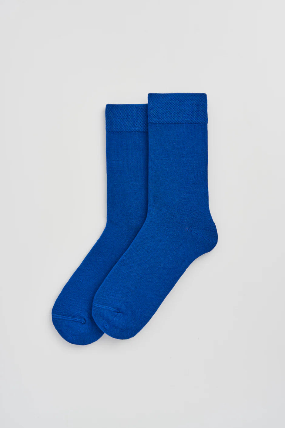 Pair of blue socks on a light grey background