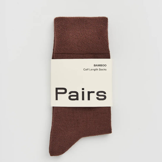 Brown sock with 'Pairs' packaging on a white background