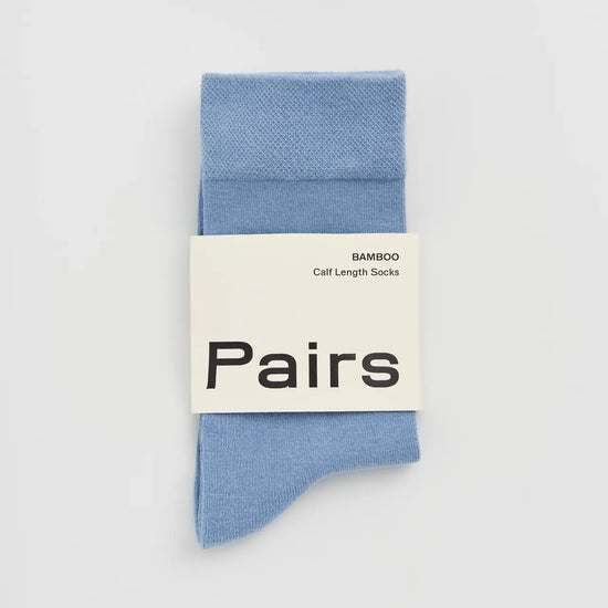 Light blue sock with a 'Pairs' label on a light grey background