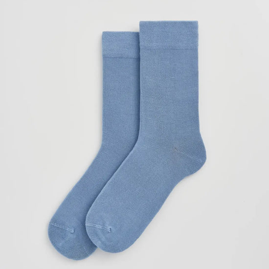 Pair of light blue socks on a white background