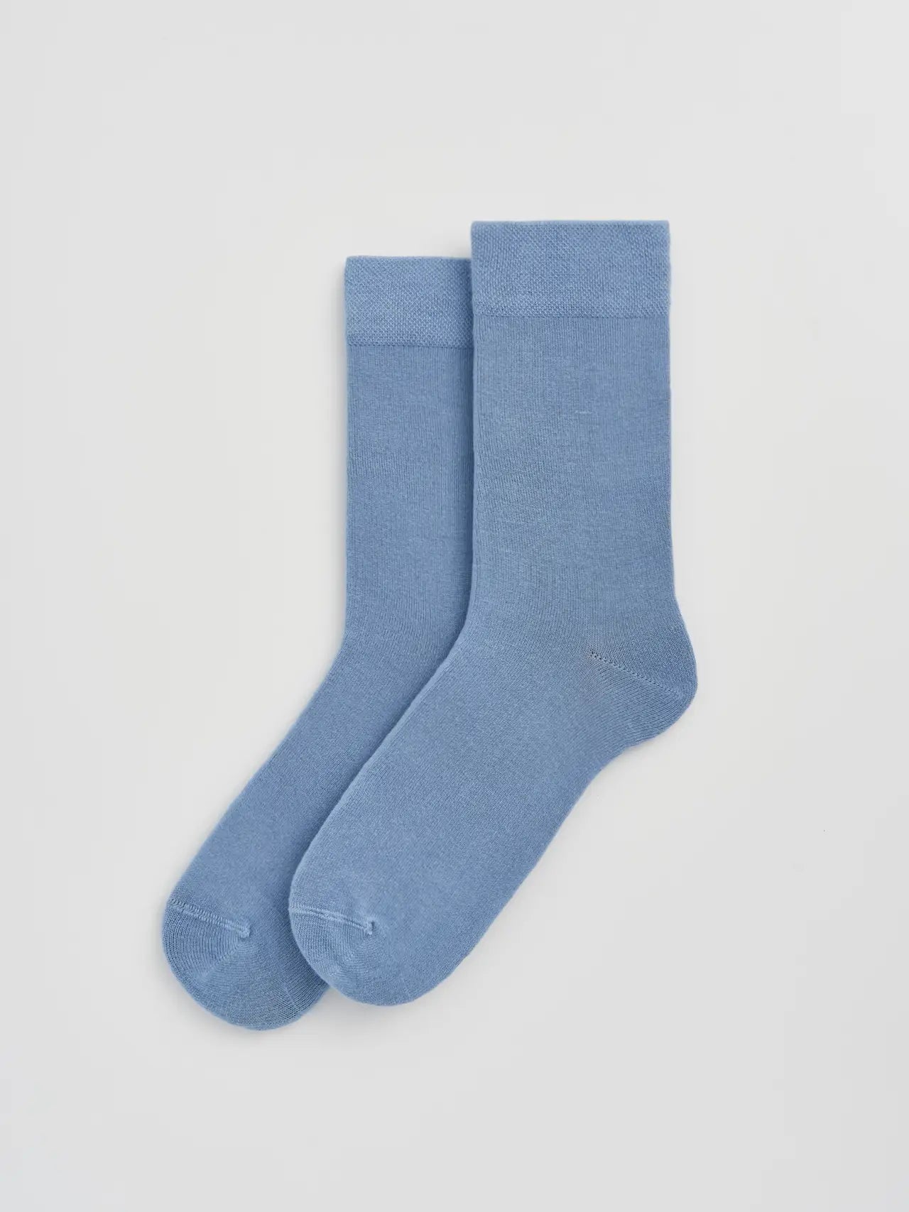 Pair of light blue socks on a white background