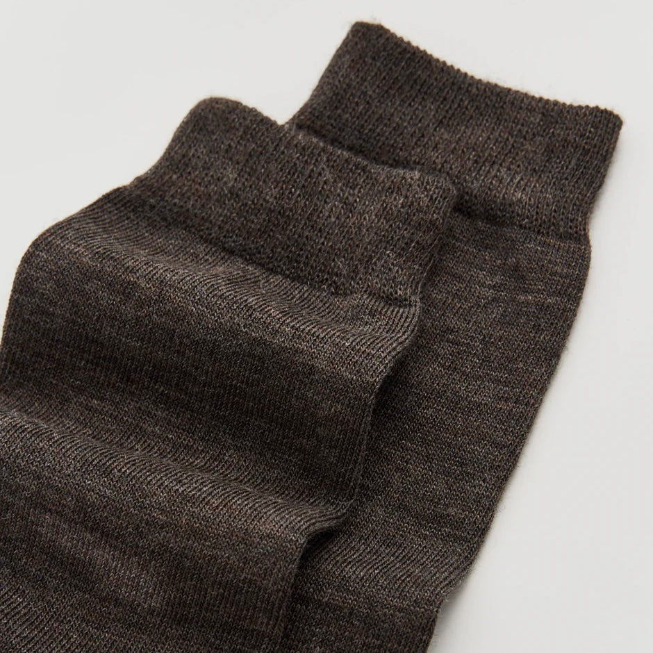 Pair of dark gray socks on a light gray background