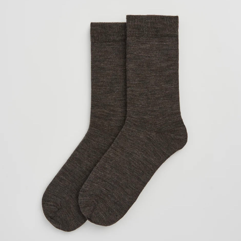 Pair of dark gray socks on a light gray background