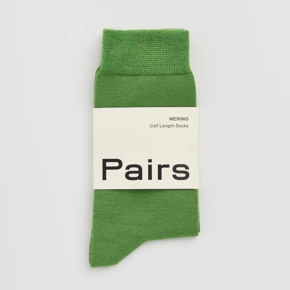 Green sock with a 'Pairs' label on a light grey background