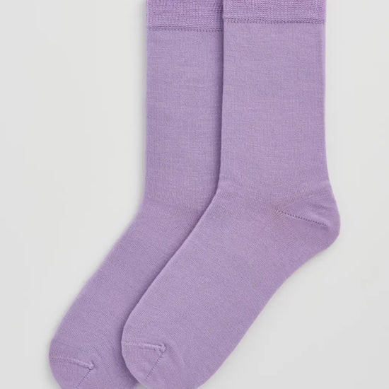 Pair of lilac socks on a light grey  background
