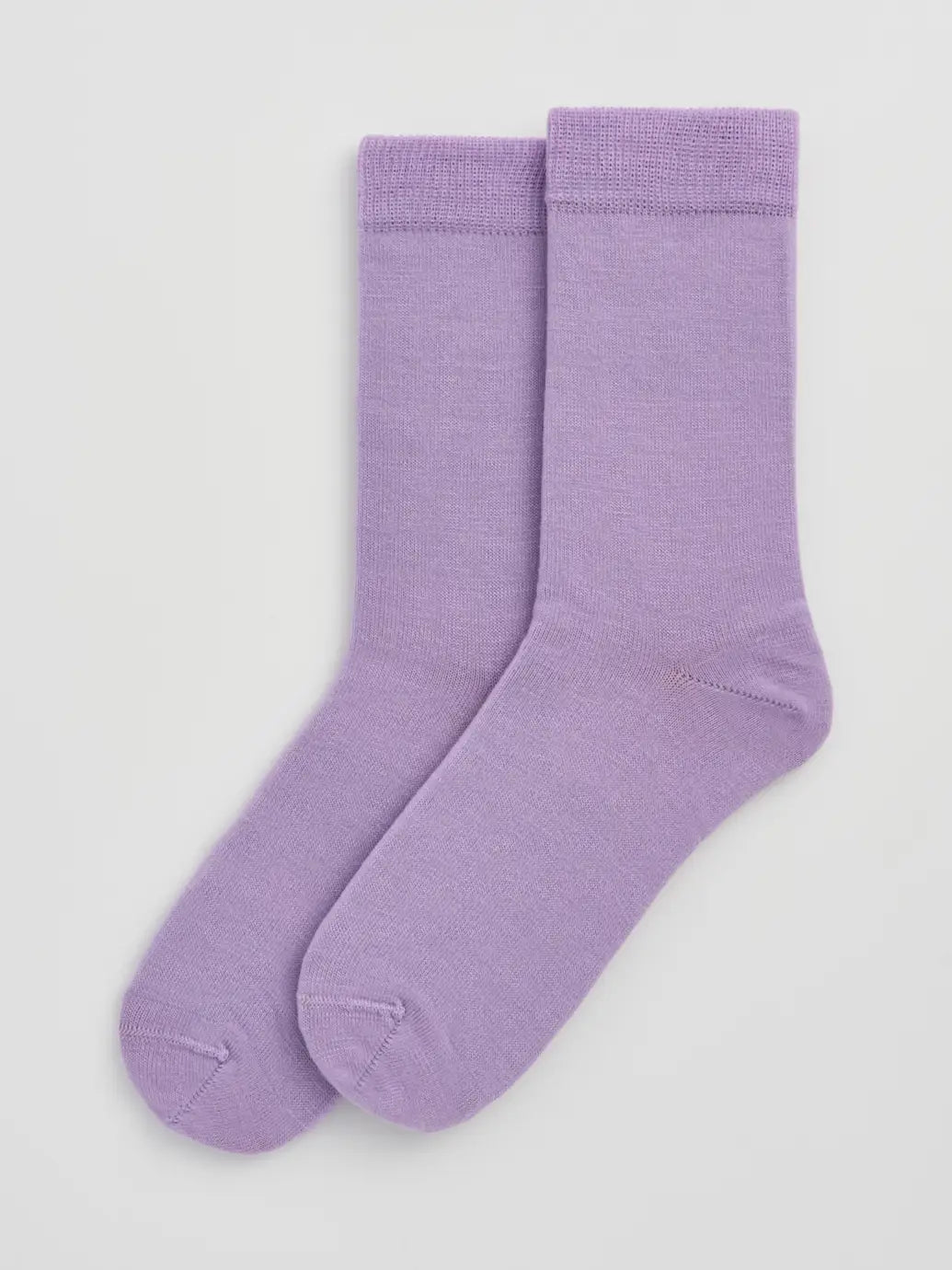 Pair of lilac socks on a light grey  background