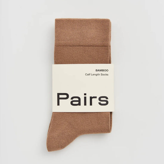 Beige sock with 'Pairs' label on a light grey background