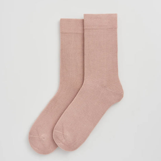 Pair of pink socks on a white background