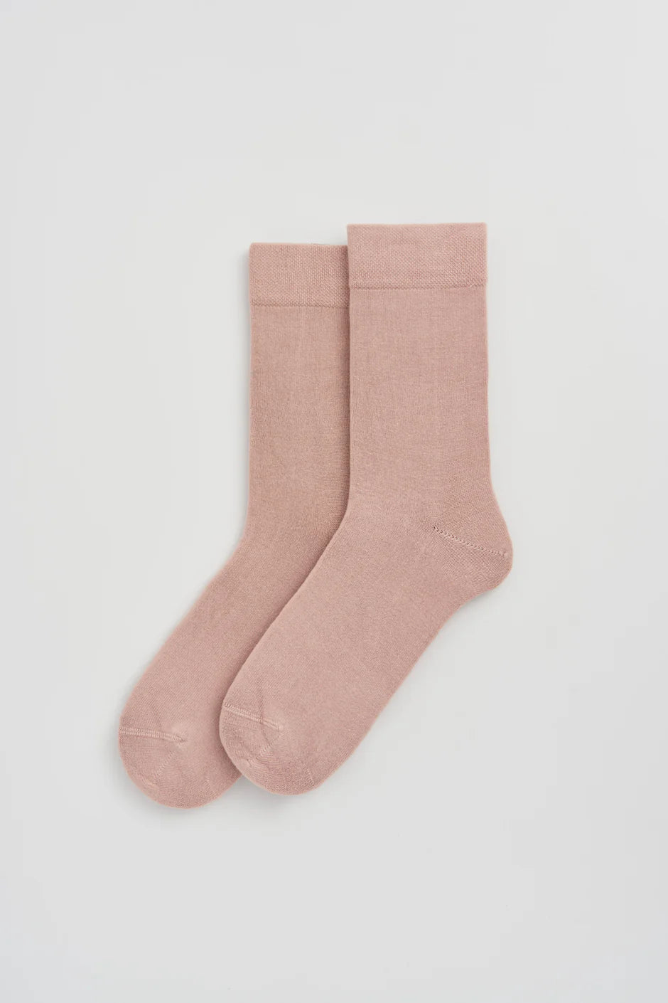 Pair of pink socks on a white background