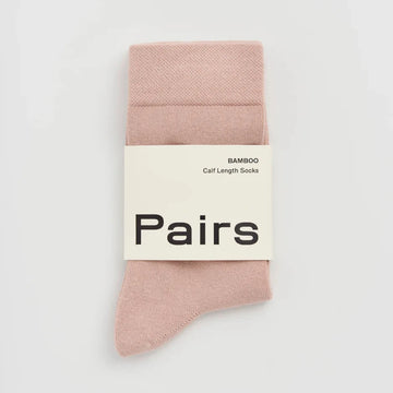 Pack of pink socks with a 'Pairs' label on a light grey background