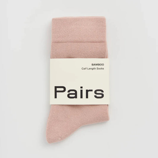 Pack of pink socks with a 'Pairs' label on a light grey background