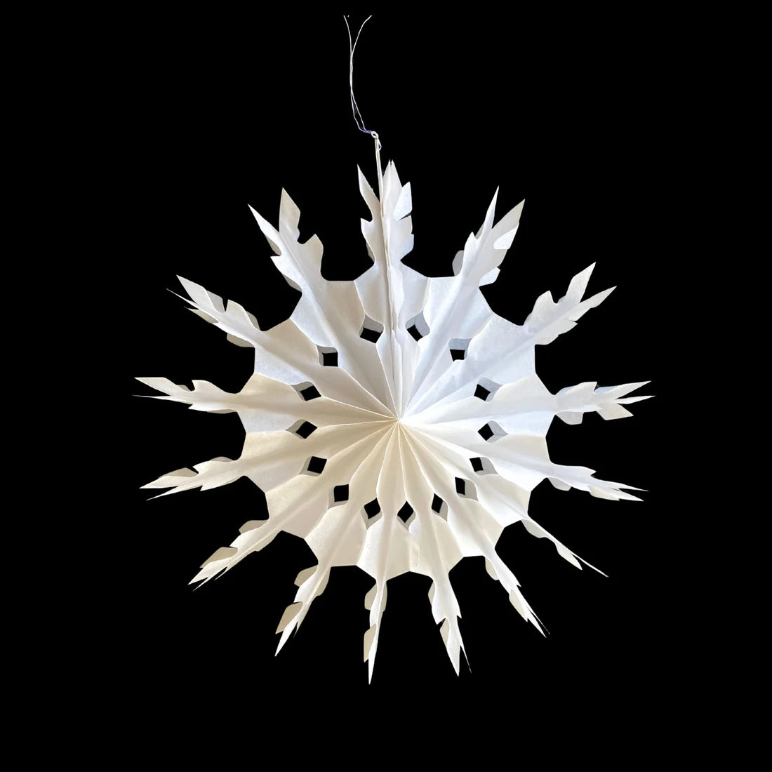White paper snowflake on a black background