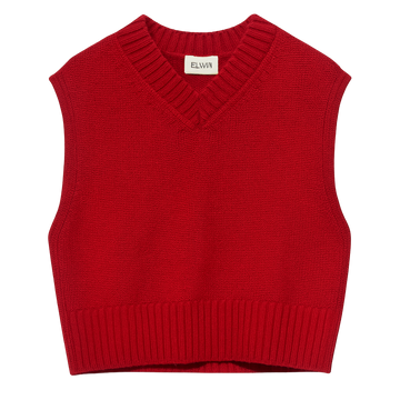 Red knitted vest on a white background