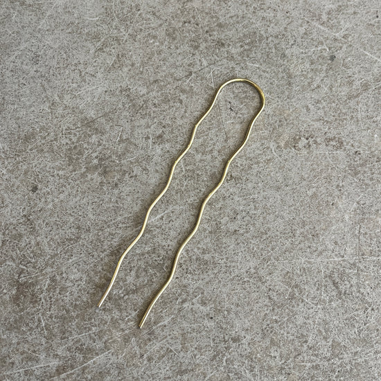 a brass wavy hairpin
