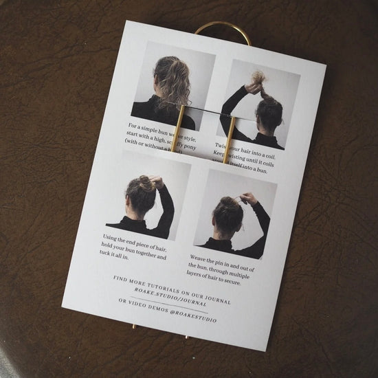 Hair pin tutorial sheet on a leather surface