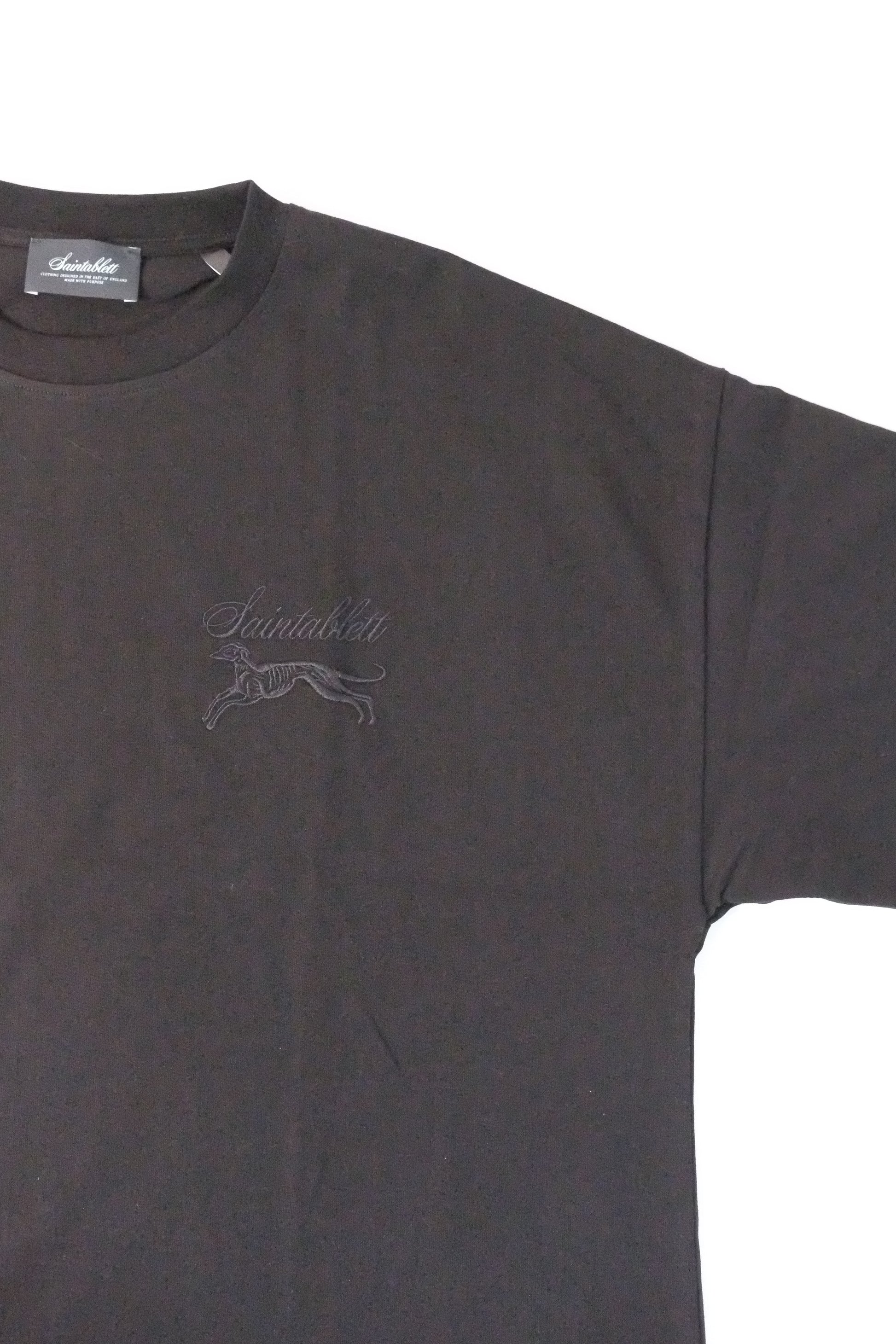 black t-shirt with a logo on a white background