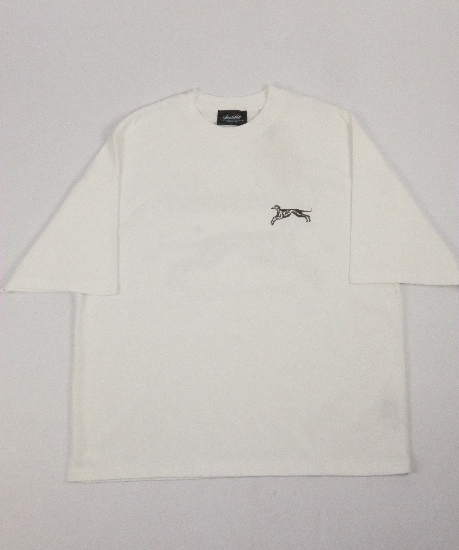 White shirt with a small logo on a light gray background