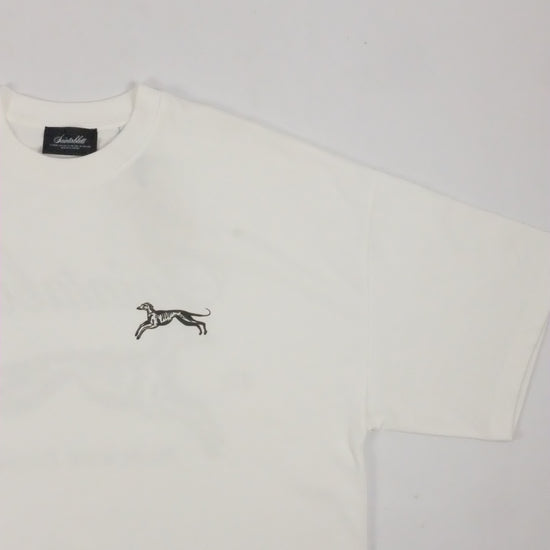 White polo shirt with a small logo on a light gray background
