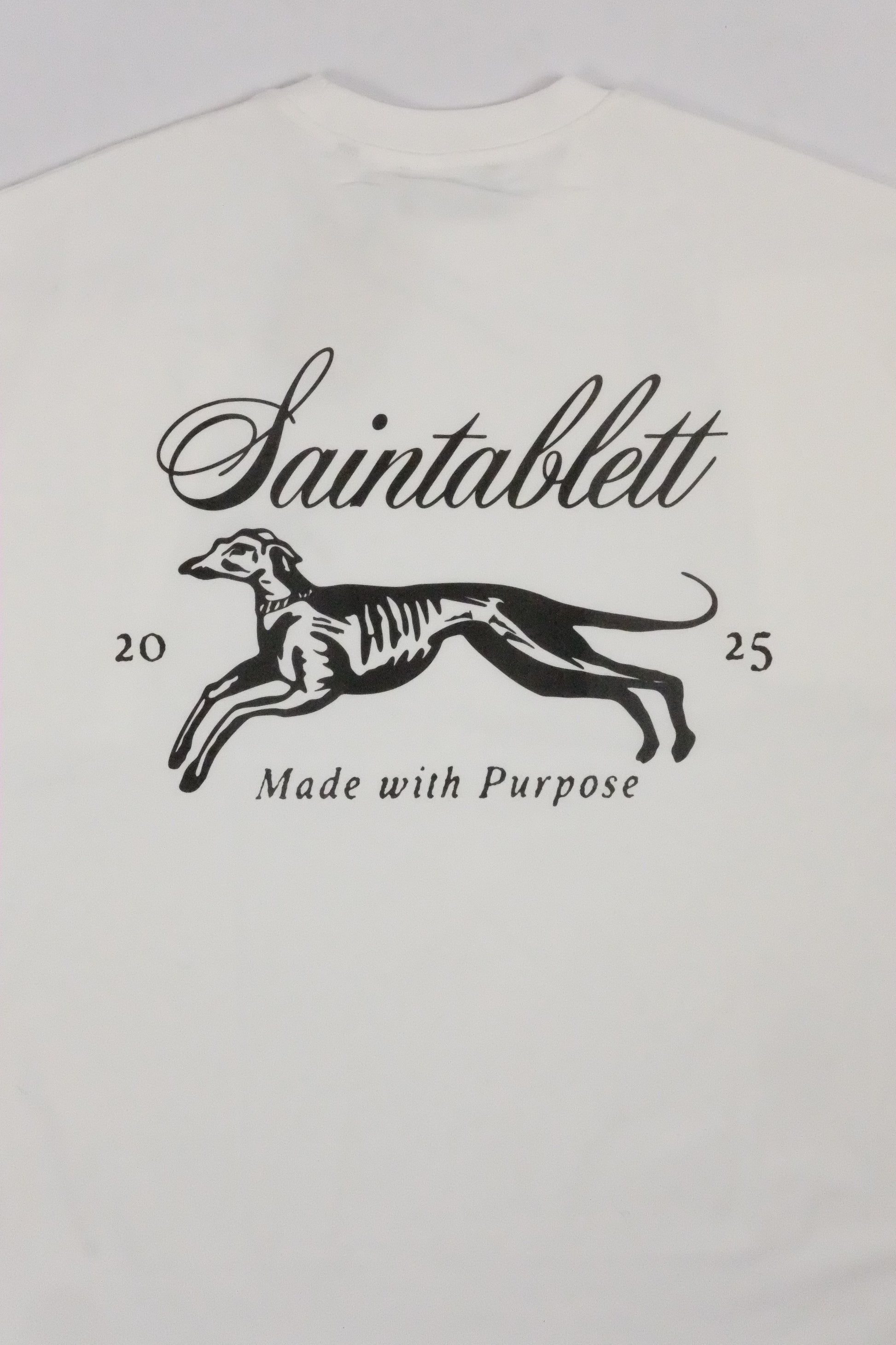 White baby onesie with black graphic and text on a white background