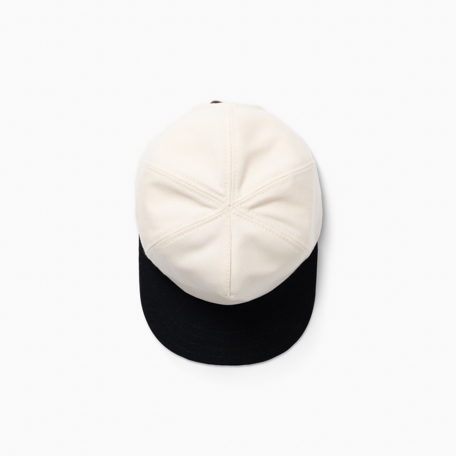 Two-tone cap with white top and black bottom on a white background