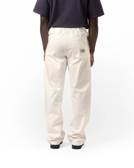 Person wearing white pants with a small logo on a white background
