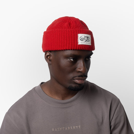 A man wearing a red cap on a white background 