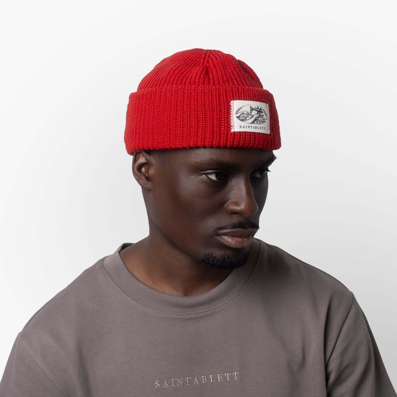 A man wearing a red cap on a white background 