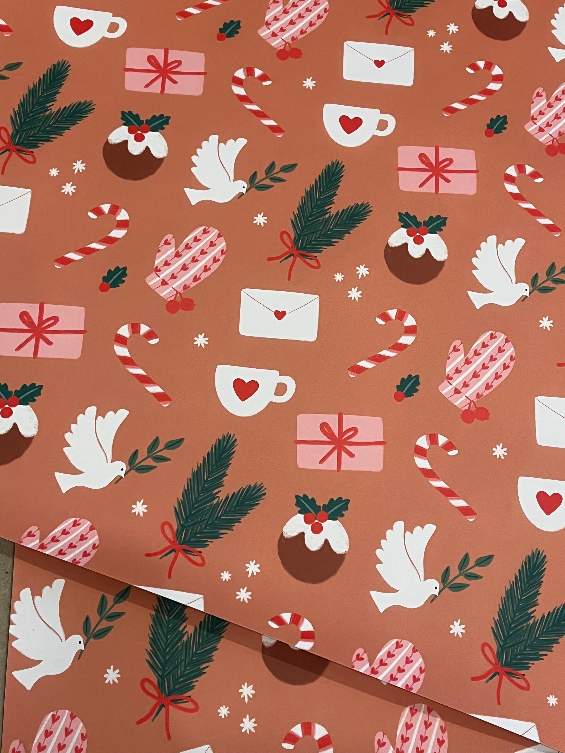 Christmas-themed wrapping paper with presents, candy canes, doves, and pine cones on a brown background.